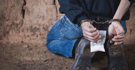man handcuffed with drugs